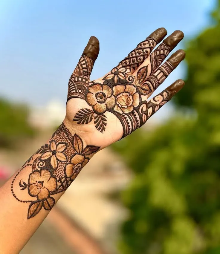 Back hand rose henna design