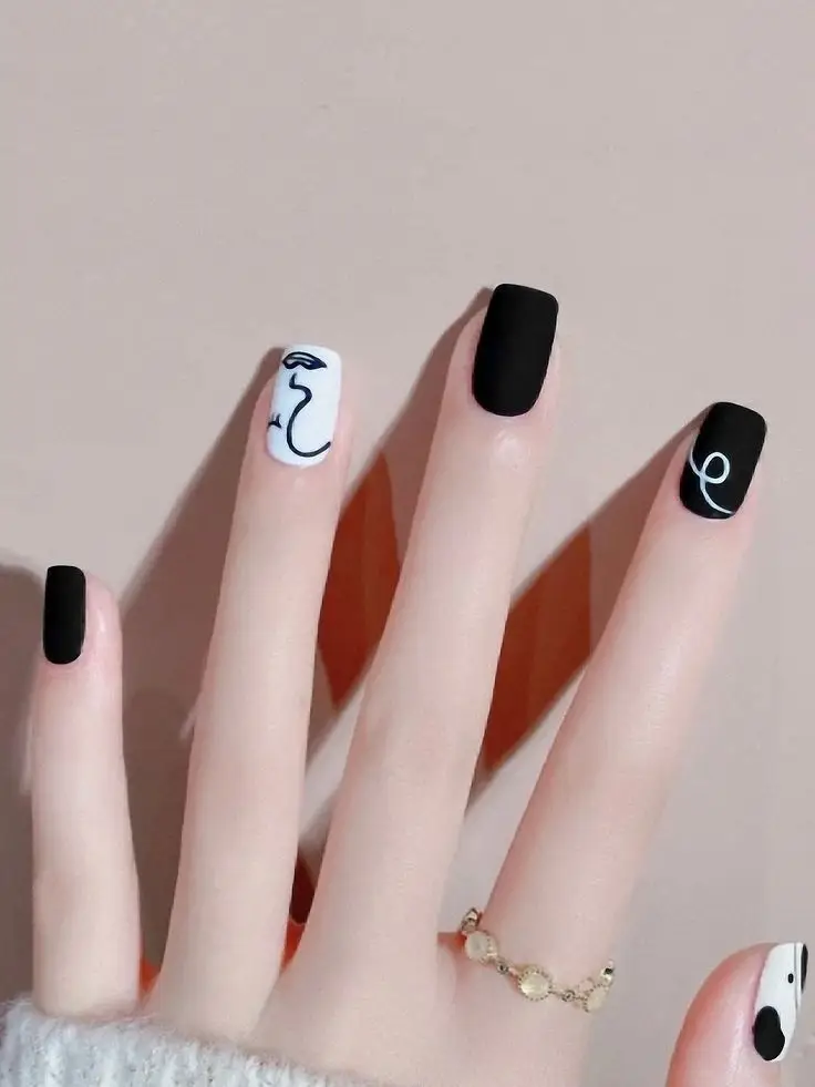 white and black polka dot nails