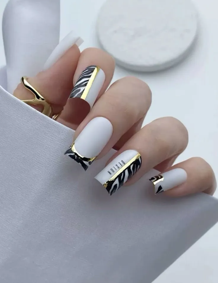 Black and white mixed with golden lines nails